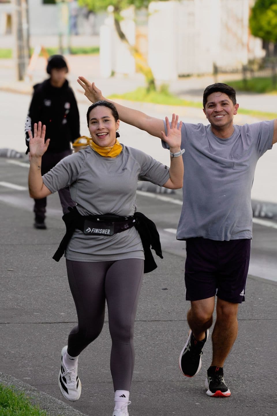 Dos corredores saludando a la cámara durante un Social Run en Concepción